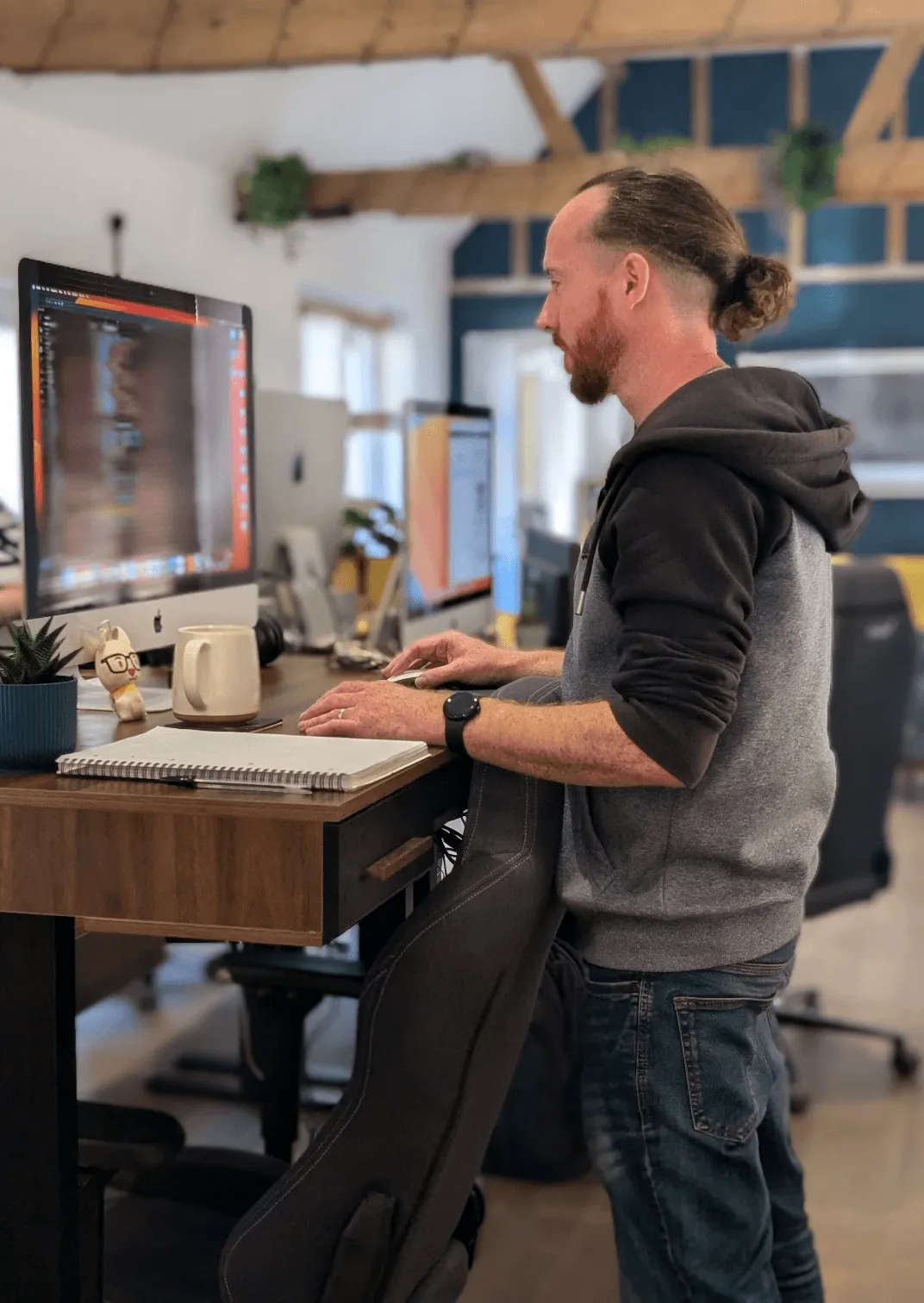 Senior developer Jim working at his desk in the Design Monkey studio